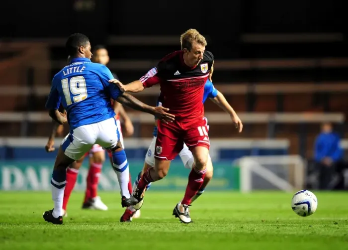 Framed Print : Bristol City's Martyn Woolford Dribbles Past Peterborough United's Mark Little in Championship Clash