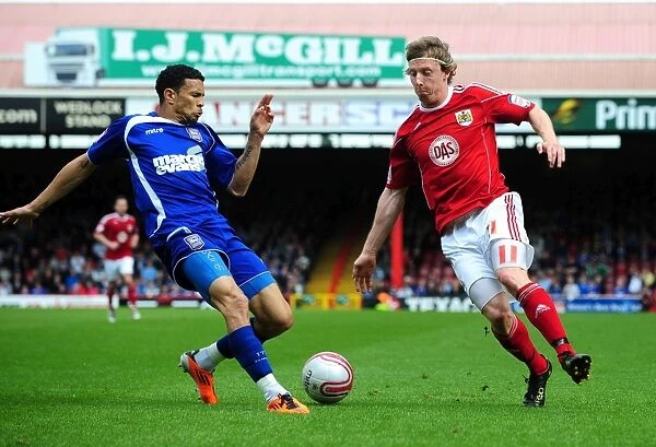 Bristol City's Martyn Woolford Outmaneuvers Ipswich's Carlos Edwards in Championship Clash at Ashton Gate, 16 / 04 / 2011
