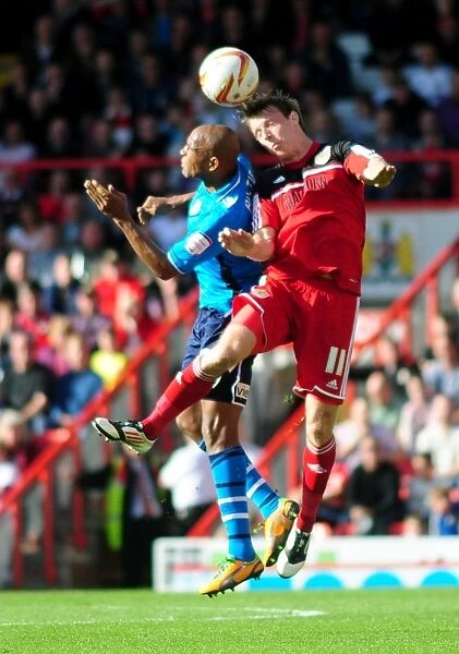Bristol City's Martyn Woolford Outmuscles Rodolph Austin for the Header in Championship Clash against Leeds United