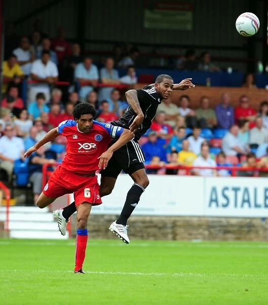 Bristol Citys Marvin Elliott challenges for the ariel ball with Aldershots Anthony Charles