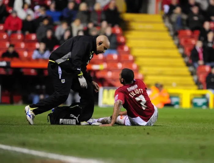 Framed Print : Bristol City's Marvin Elliott Receives Treatment During Championship Match vs Barnsley (23 / 03 / 2010) Framed Print : Bristol City's Marvin Elliott Receives Treatment During Championship Match vs Barnsley (23 / 03 / 2010)