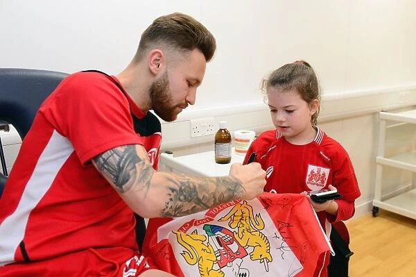 Bristol City's Matty Taylor Signs Autographs for Mascot Before Fulham Match