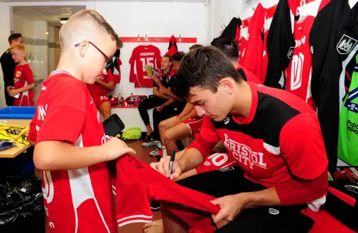 Framed Print : Bristol City's Max O'Leary Signs Autograph for Mascot in Changing Room during Bristol City v Wigan Athletic Match Framed Print : Bristol City's Max O'Leary Signs Autograph for Mascot in Changing Room during Bristol City v Wigan Athletic Match