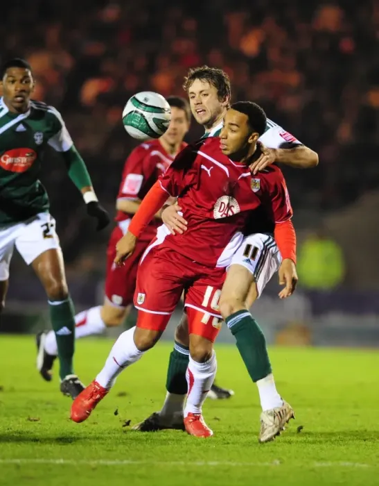Framed Print : Bristol City's Nicky Maynard vs. Plymouth Argyle's Kari Arnason: Championship Clash at Home Park, 16th March 2010