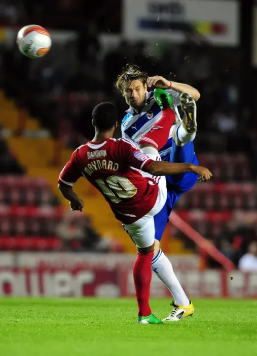 Framed Print : Bristol City's Nicky Maynard vs. Kaspars Gorkss: Battle for the Ball in Championship Match between Bristol City and Reading (September 27, 2011)