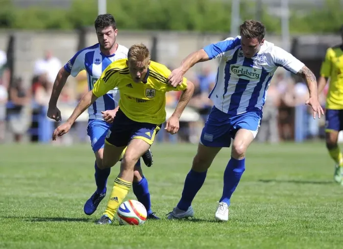 Framed Print : Bristol City's Rhys Jordan Fights for Possession Against Clevedon Town Defense in Pre-Season Friendly Framed Print : Bristol City's Rhys Jordan Fights for Possession Against Clevedon Town Defense in Pre-Season Friendly