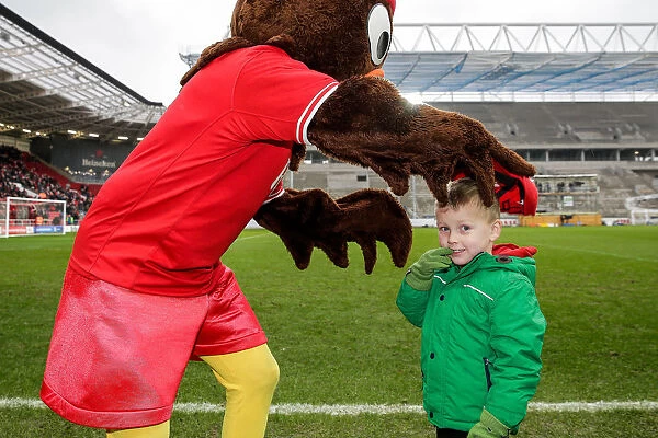 Bristol City's Scrumpy Mascot Delights Young Fan with Cap Presentation at Half-Time