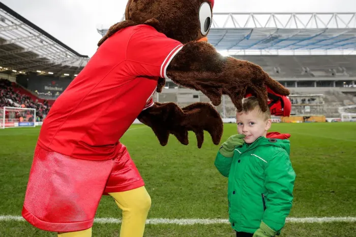 Framed Print : Bristol City's Scrumpy Mascot Delights Young Fan with Cap Presentation at Half-Time Framed Print : Bristol City's Scrumpy Mascot Delights Young Fan with Cap Presentation at Half-Time