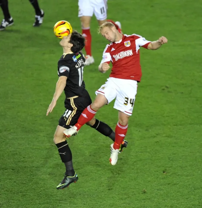 Framed Print : Bristol City's Simon Gillett and Crawley Town's Josh Simpson Battle for High Ball in Cardiff City vs Swansea City Match Framed Print : Bristol City's Simon Gillett and Crawley Town's Josh Simpson Battle for High Ball in Cardiff City vs Swansea City Match