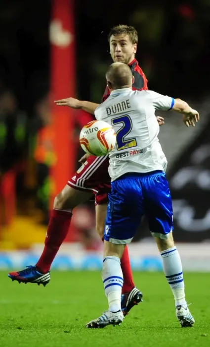 Framed Print : Bristol City's Steven Davies Battles for Header Against Millwall's Alan Dunne in Championship Match Framed Print : Bristol City's Steven Davies Battles for Header Against Millwall's Alan Dunne in Championship Match