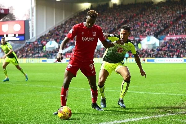 Bristol City's Tammy Abraham Fends Off Reading's Liam Moore in Championship Clash