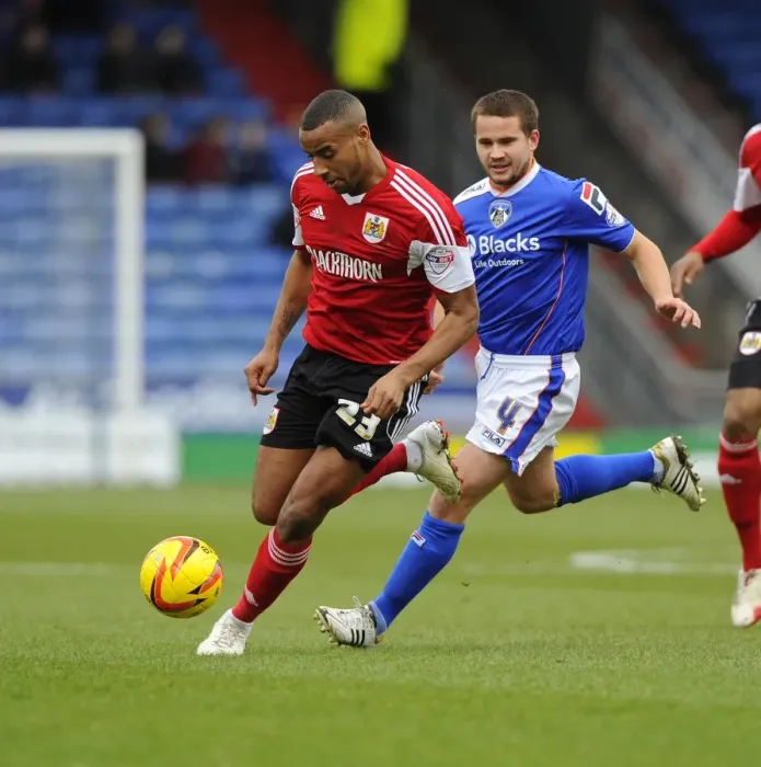 Framed Print : Bristol City's Tyrone Barnett Fights for Possession Against Oldham Athletic's James Wesolowski in Sky Bet League One Clash