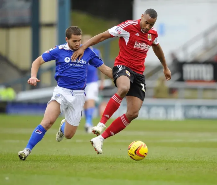 Framed Print : Bristol City's Tyrone Barnett vs Oldham Athletic's James Wesolowski: A Fight for Supremacy in Sky Bet League One