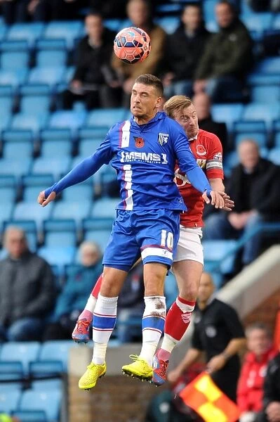 Bristol City's Wade Elliott and Cody McDonald Clash for Header in FA Cup Match against Gillingham
