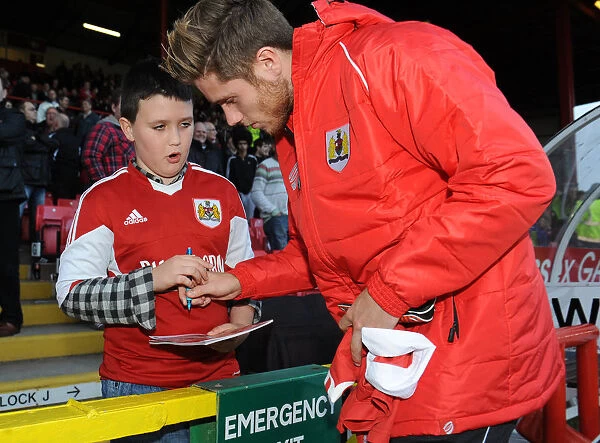 Bristol City's Wes Burns Signs Autograph for Fan at Ashton Gate