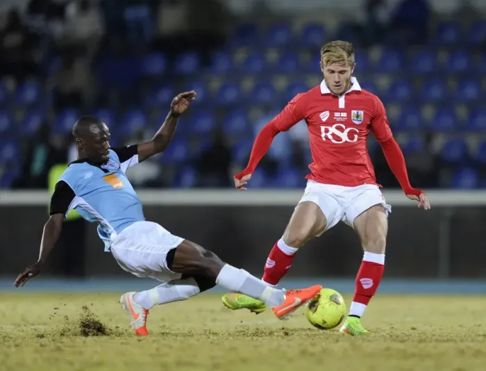 Framed Print : Bristol City's Wes Burns Tackled During Botswana Tour Match Framed Print : Bristol City's Wes Burns Tackled During Botswana Tour Match