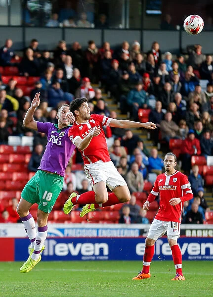 Bristol City's Wilbraham and Barnsley's Dudgeon Battle in the Air at Oakwell Stadium