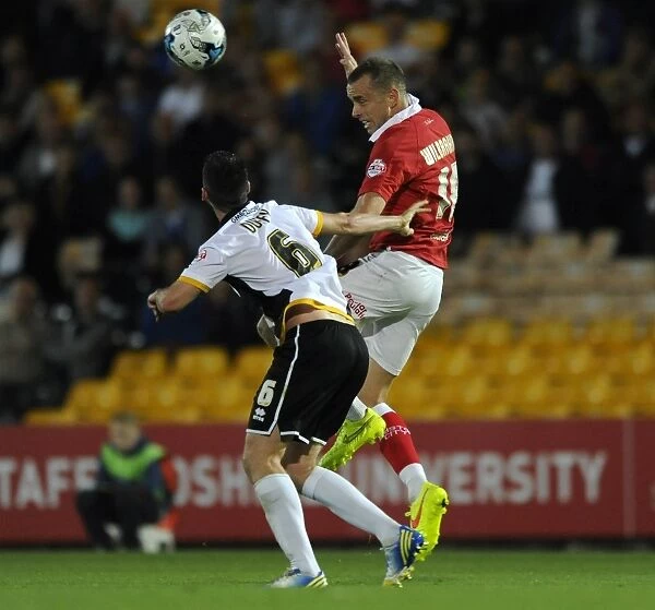 Bristol City's Wilbraham Outjumps Duffy to Head the Ball in Port Vale vs. Bristol City Football Match, September 16, 2014