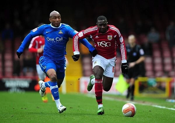 Bristol City's Yannick Bolasie Fends Off Doncaster Rovers El-Hadji Diouf in Championship Clash - 21 / 01 / 2012