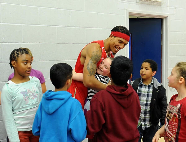 Bristol Flyers Basketball: Greg Streete Embraces Young Fan Amidst Cheers at Wise Campus