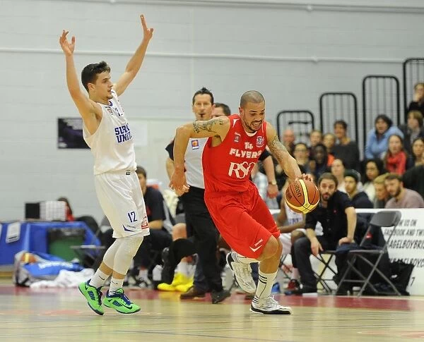 Bristol Flyers Doug McLaughlin-Williams Charges Forward Against Surrey United in Basketball Action