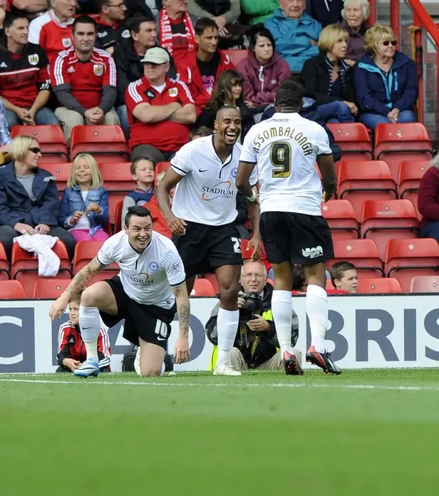 Framed Print : Celebrating the Goal: Barnett, Assombalonga, and Tomlin of Peterborough United at Ashton Gate after Scoring against Bristol City (September 14, 2013)