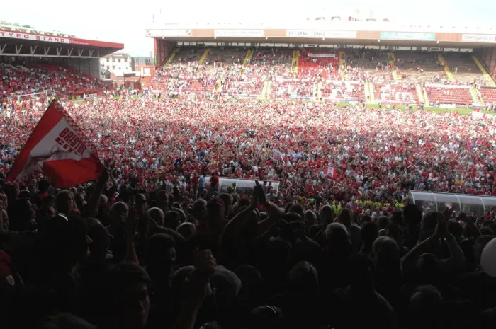 Framed Print : Celebrating Promotion: Thrilled Fans Invade the Pitch at Bristol City Football Club