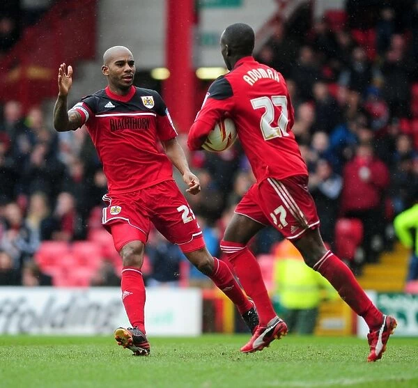 Celebration: Adomah, Davies, and Elliott Rejoice in Bristol City's Goal Against Bolton Wanderers (13 / 04 / 2013)