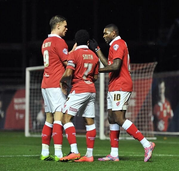 Celebration: Jay Emmanuel-Thomas, Matt Smith, and Korey Smith of Bristol City after scoring against Doncaster Rovers in FA Cup Third Round Replay at Ashton Gate Stadium (13 / 01 / 2015)