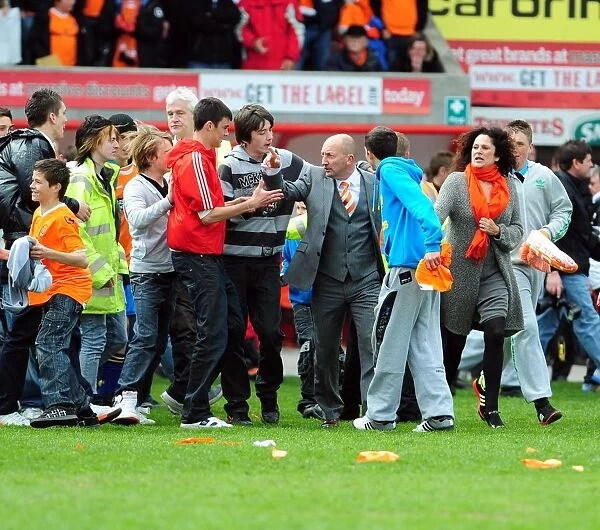 Championship Glory: Blackpool Fans Emotional Pitch Invasion as Ian Holloway Celebrates Title Win vs. Bristol City (02 / 05 / 2010)
