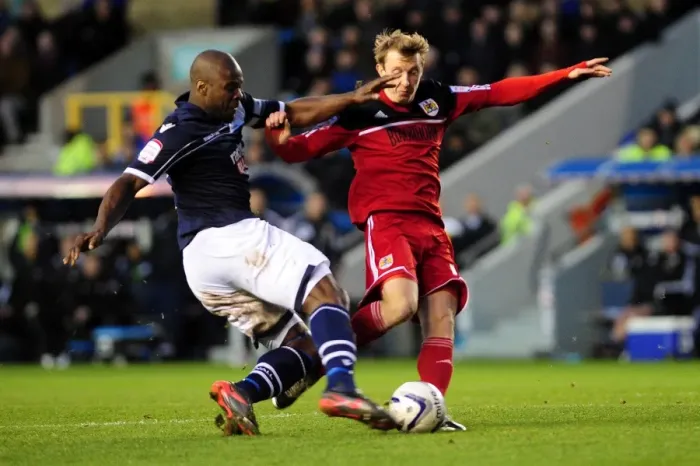 Framed Print : Championship Showdown: Intense Moment as Millwall's Danny Shittu Challenges Bristol City's Martyn Woolford in the Penalty Box Framed Print : Championship Showdown: Intense Moment as Millwall's Danny Shittu Challenges Bristol City's Martyn Woolford in the Penalty Box