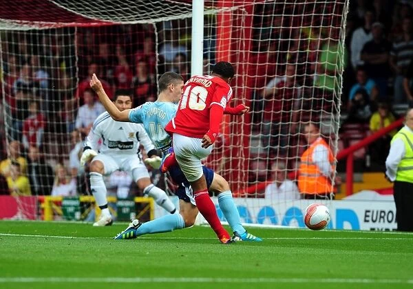 Championship Showdown: Nicky Maynard's Goal Attempt Blocked by Joe Dudgeon in Bristol City vs. Hull City Match (September 24, 2011)
