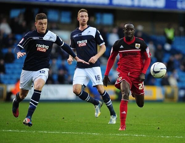 Chasing the Win: Albert Adomah Pursues Loose Ball in Intense Millwall vs. Bristol City Championship Match