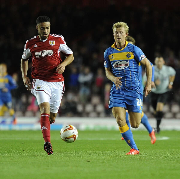 Chasing the Win: Intense Moment as Curtis Main of Shrewsbury Town Pursues Derrick Williams of Bristol City
