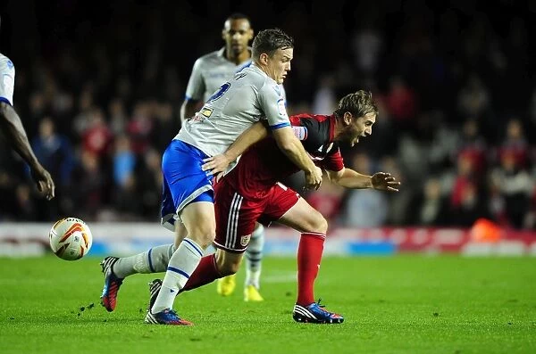 Clash at Ashton Gate: Intense Moment as Shane Lowry of Millwall and Steven Davies of Bristol City Battle for the Ball