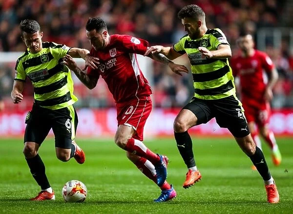 Clash at Ashton Gate: Lee Tomlin Stares Down Huddersfield's Hogg and Smith