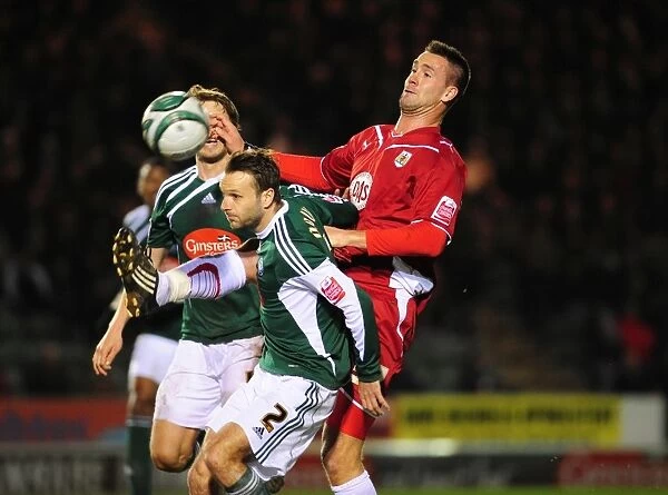 Clash in the Championship: Stefan Maierhofer of Bristol City Battles Karl Duguid of Plymouth Argyle for an Aerial Ball