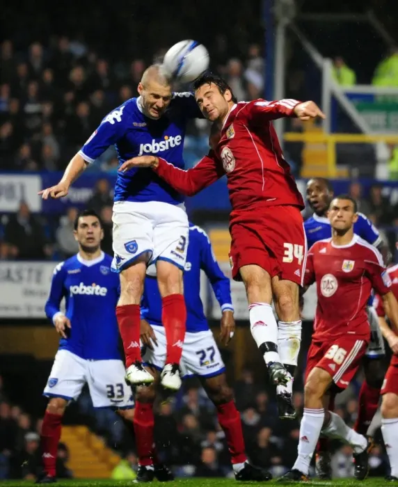 Framed Print : Clash at Fratton Park: Dickinson vs. Pitman Battle for Aerial Supremacy in Portsmouth vs. Bristol City Championship Clash (September 2010)