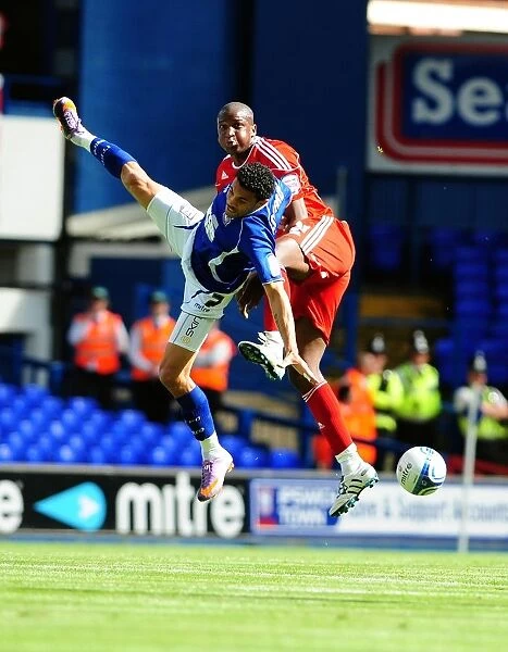 Clash in the Sky: Cisse vs. Edwards - Championship Showdown (August 2010) - Ipswich v Bristol City: Kalifa Cisse Challenges Carlos Edwards for the Aerial Ball