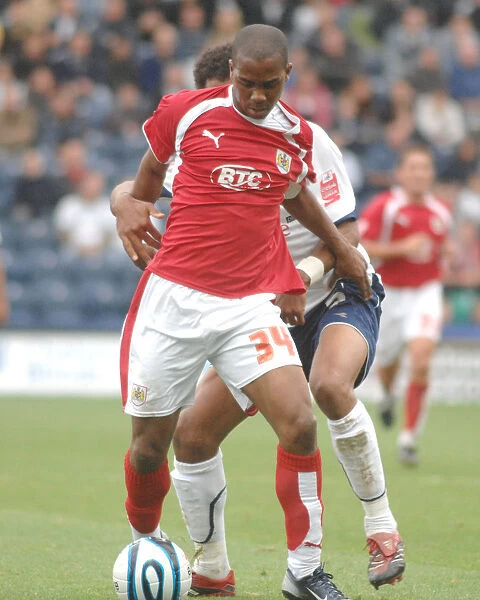 Darren Byfield tries to wrigggle past the preston defence
