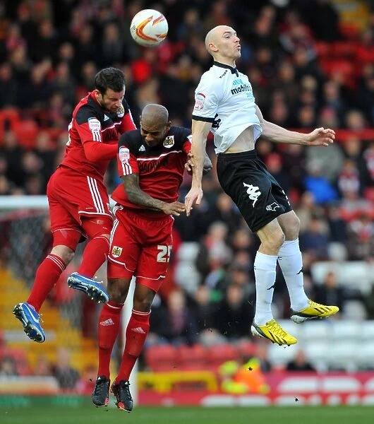 Derby County's Conor Sammon Leaps Above Bristol City's Marvin Elliott and Richard Foster