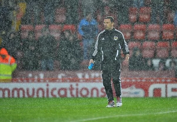 Derek McInnes Examines the Floodlit Pitch as Referee Halts Bristol City vs. Watford Match