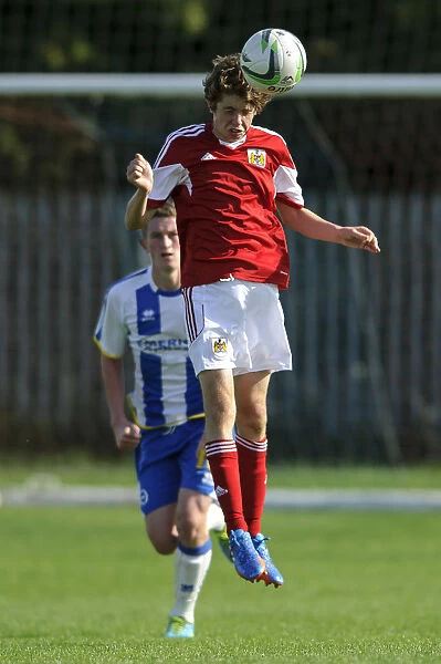 Determined Tom Fry Heads the Ball for Bristol City U18 against Brighton & Hove Albion U18