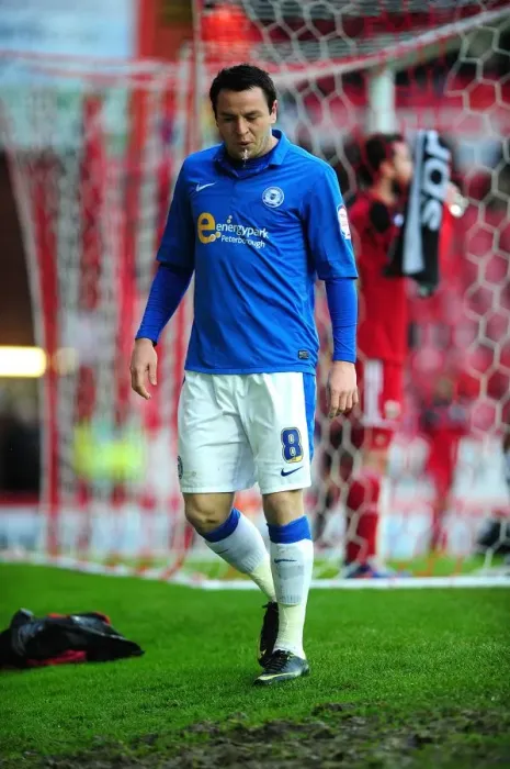 Framed Print : Disappointment for Peterborough's Lee Tomlin: Red Card at Ashton Gate (Bristol City vs Peterborough, December 2012)