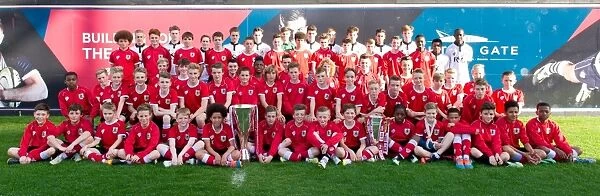 Double Promotion Triumph: Bristol City Academy Players Celebrate with Johnstones Paint and Sky Bet League One Trophies