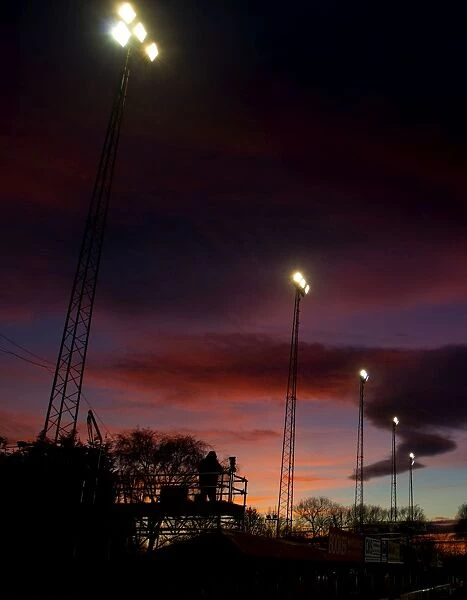 FA Cup Sunset: ITV Cameraman and Floodlights Silhouetted at Tamworth's The Lamb Ground