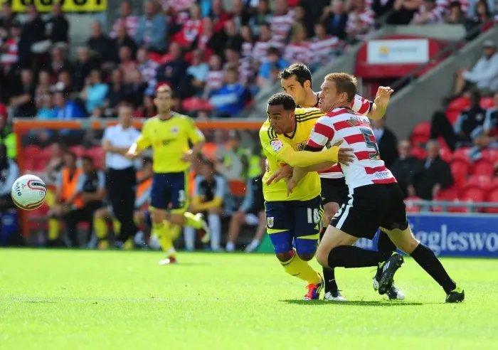 Framed Print : Football Rivalry: Nicky Maynard vs Richard Naylor in the 2011 League Cup Clash between Doncaster Rovers and Bristol City