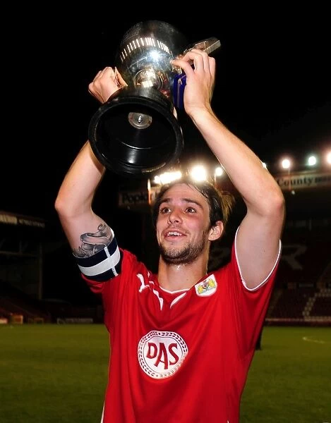 Frankie Artus Celebrates Glos Cup Victory with Trophy Lift at Bristol City