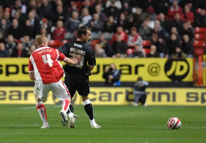 Framed Print : Gavin Williams backheels the ball past Charltons Nicky Baily Framed Print : Gavin Williams backheels the ball past Charltons Nicky Baily