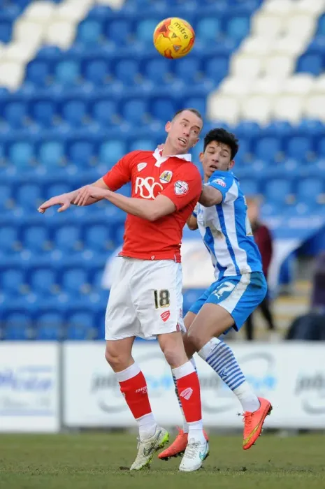 Framed Print : Intense Aerial Battle: Wilbraham vs. Bonne in Colchester United vs. Bristol City Football Match, 2015